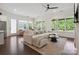 Bright living room featuring a neutral color palette, hardwood flooring and large windows overlooking lush landscaping at 4922 Looking Glass Trl, Denver, NC 28037