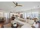 Open-concept living room with white walls and hardwood flooring with a view into the kitchen and adjacent breakfast area at 4922 Looking Glass Trl, Denver, NC 28037