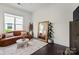 Cozy living room with a leather couch, modern mirror, and stylish decor at 4922 Looking Glass Trl, Denver, NC 28037