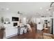 Bright, open-concept living space with hardwood floors, fireplace, and seamless flow to dining and kitchen areas at 4922 Looking Glass Trl, Denver, NC 28037