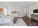 Bright main bedroom features a ceiling fan, hardwood floors, an area rug, and white walls with white trim at 4922 Looking Glass Trl, Denver, NC 28037