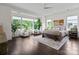 Primary bedroom with hardwood floors, large windows, and neutral furniture, creating a peaceful and inviting atmosphere at 4922 Looking Glass Trl, Denver, NC 28037