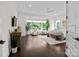 Primary bedroom featuring hardwood flooring, neutral walls, a large picture window, and an adjacent sitting area at 4922 Looking Glass Trl, Denver, NC 28037