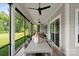 Relaxing screened porch offers outdoor seating, ceiling fans and views of the landscaped yard at 4922 Looking Glass Trl, Denver, NC 28037