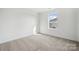Comfortable bedroom with soft carpet and a bright window allowing natural light at 557 Mountain View Dr, Monroe, NC 28110