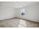 Bright bedroom with neutral carpet and a large window providing a relaxing atmosphere at 557 Mountain View Dr, Monroe, NC 28110