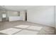 A spacious bonus room with neutral carpet and bright natural light creates a versatile space for work or play at 557 Mountain View Dr, Monroe, NC 28110