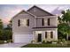 Charming two-story home showcasing a manicured lawn, a two-car garage, and a covered front porch at 557 Mountain View Dr, Monroe, NC 28110