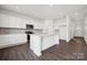 Kitchen with island, quartz countertops, and modern stainless steel appliances at 557 Mountain View Dr, Monroe, NC 28110