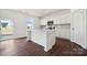 Modern kitchen featuring an island, quartz countertops, sleek white cabinets and stainless steel appliances at 557 Mountain View Dr, Monroe, NC 28110