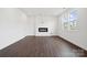 Living room featuring an electric fireplace, wood flooring, and natural light at 557 Mountain View Dr, Monroe, NC 28110