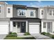 Modern townhome featuring neutral colors, a one-car garage, a covered front porch, and low-maintenance landscaping at 7008 Matz Way, Charlotte, NC 28269