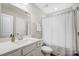 Clean bathroom with single vanity, a mirror, and a shower-tub combination with white curtain at 7348 Adirondack Dr, Denver, NC 28037