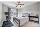 Comfortable bedroom with ceiling fan, large window and dark metal bed frame at 7348 Adirondack Dr, Denver, NC 28037