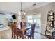 Dining area with wood table, with open view to a living area and outdoor patio access at 7348 Adirondack Dr, Denver, NC 28037