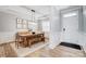 Formal dining area features a wood table, wainscoting, and a modern chandelier at 7348 Adirondack Dr, Denver, NC 28037