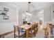 Bright dining room with wood table, neutral walls and modern light fixture at 7348 Adirondack Dr, Denver, NC 28037