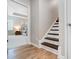 Inviting hallway with hardwood floors and a staircase with contrasting dark steps at 7348 Adirondack Dr, Denver, NC 28037