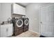 Bright laundry room features modern washer, dryer, sink and storage at 7348 Adirondack Dr, Denver, NC 28037