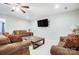 Open concept living room featuring hardwood floors, ceiling fan, and comfortable seating at 7348 Adirondack Dr, Denver, NC 28037