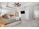 Bright main bedroom showcasing a tray ceiling, fan, and modern furnishings at 7348 Adirondack Dr, Denver, NC 28037