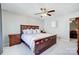 Spacious main bedroom features a ceiling fan and a wooden bed frame with side tables at 7348 Adirondack Dr, Denver, NC 28037