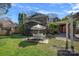 Back exterior view of home with screened-in porch and lush green backyard at 7824 Hickory Stick Pl, Charlotte, NC 28277