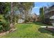 Backyard with green grass and a storage shed near a wood fence and landscaping at 7824 Hickory Stick Pl, Charlotte, NC 28277