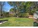 Green backyard with grass and trees, and a swing set at 7824 Hickory Stick Pl, Charlotte, NC 28277