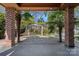 Covered patio with palm trees overlooking backyard with pergola-covered patio at 7824 Hickory Stick Pl, Charlotte, NC 28277