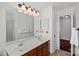 Bright bathroom with double sink vanity, large mirror, and tile flooring at 7824 Hickory Stick Pl, Charlotte, NC 28277