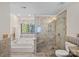 Luxurious bathroom featuring a glass-enclosed shower, soaking tub, and tile accents at 7824 Hickory Stick Pl, Charlotte, NC 28277