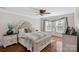 Comfortable bedroom with hardwood floors, large window, and a beautifully decorated bed with accent pillows at 7824 Hickory Stick Pl, Charlotte, NC 28277