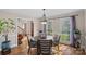 Elegant dining room with a round table, hardwood floors, and a decorative light fixture at 7824 Hickory Stick Pl, Charlotte, NC 28277