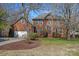 Beautiful two-story brick home with mature landscaping, attached garage and a well-manicured lawn at 7824 Hickory Stick Pl, Charlotte, NC 28277