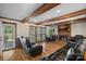 Cozy living room featuring hardwood floors, a brick fireplace, and comfortable leather seating at 7824 Hickory Stick Pl, Charlotte, NC 28277