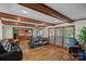 Bright living room with hardwood floors, comfortable leather seating, and an open view of the kitchen at 7824 Hickory Stick Pl, Charlotte, NC 28277