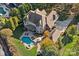 Beautiful aerial view of a brick home featuring a private backyard pool, patio area, and mature landscaping at 8724 Highgrove St, Charlotte, NC 28277