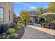 Beautifully landscaped backyard with a brick patio, dining set, and lush greenery at 8724 Highgrove St, Charlotte, NC 28277