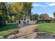 Outdoor entertainment area features a stone fireplace, seating, grilling area, and lush lawn at 8724 Highgrove St, Charlotte, NC 28277