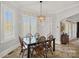 Bright dining room with large windows and elegant lighting fixture at 8724 Highgrove St, Charlotte, NC 28277