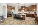Spacious kitchen featuring dark wood cabinetry, stainless steel appliances, and center island with bar seating at 8724 Highgrove St, Charlotte, NC 28277