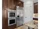 This kitchen features stainless steel appliances and rich dark cabinetry at 8724 Highgrove St, Charlotte, NC 28277