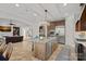 Open concept kitchen with island, seamlessly connecting to the living area and fireplace at 8724 Highgrove St, Charlotte, NC 28277