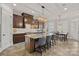 A spacious kitchen with a large center island, granite countertops, and ample seating at 8724 Highgrove St, Charlotte, NC 28277