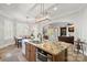 Kitchen island features a sink and granite countertop, with a view into the living room at 8724 Highgrove St, Charlotte, NC 28277
