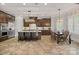 Gourmet kitchen with stainless steel appliances, center island, and dark wood cabinets, perfect for culinary enthusiasts at 8724 Highgrove St, Charlotte, NC 28277
