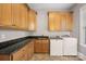 Functional laundry room equipped with modern appliances, granite countertops, and ample cabinet space at 8724 Highgrove St, Charlotte, NC 28277