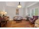 Cozy living room with hardwood floors, decorative chandelier, and comfortable seating arrangement at 8724 Highgrove St, Charlotte, NC 28277
