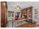 Cozy office with custom built-in bookcases, desk, and a large window at 8724 Highgrove St, Charlotte, NC 28277